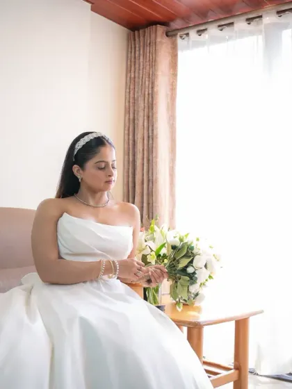 A serene bridal portrait taken in a brightly lit room. The bride looks calm and beautiful as she prepares for her wedding.