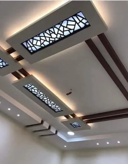 This design features rectangular panels with intricate geometric cutouts. The backlighting shines through the patterns, creating a beautiful play of light and shadow.