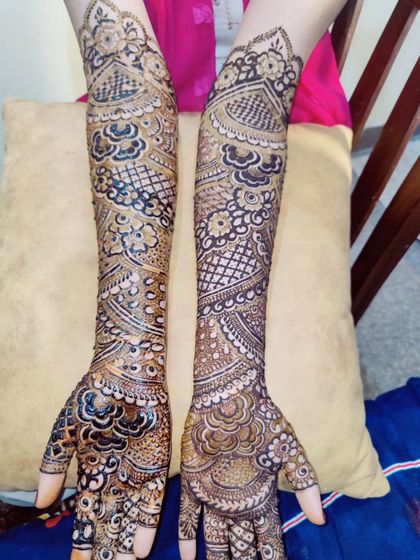 This image showcases a symmetrical design on both arms, featuring a mix of peacocks, florals, and geometric fills.