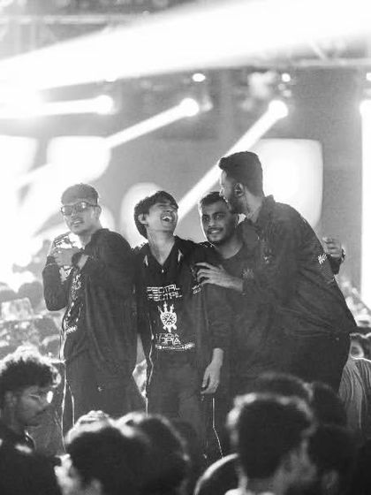 A black and white shot of friends celebrating in the crowd, capturing a timeless moment of camaraderie.