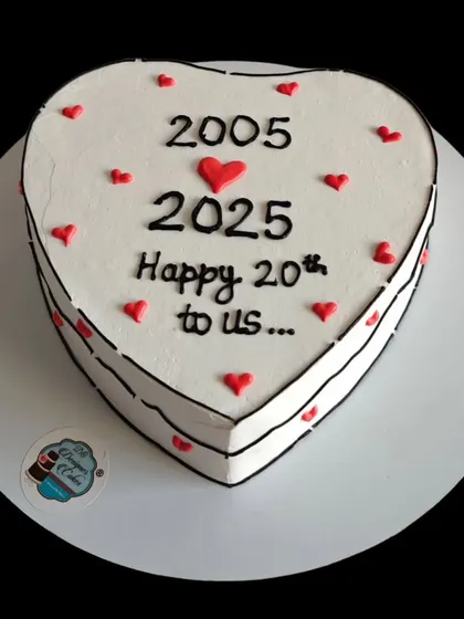 A heart-shaped comic-style cake celebrating a 20th anniversary from 2005 to 2025. This is a fun and modern way to mark two decades of love.