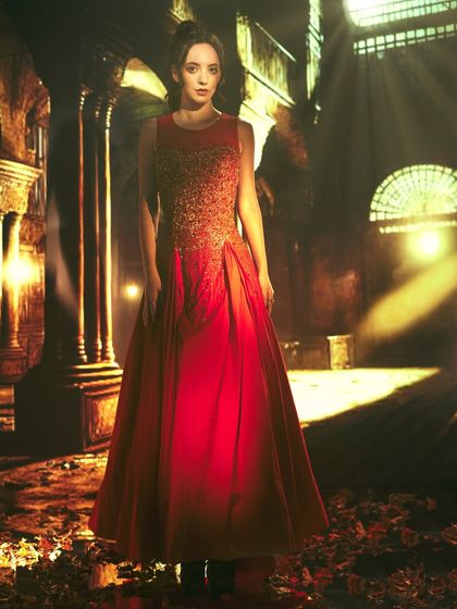 This dramatic portrait uses a projected backdrop of ancient ruins with light streaming through. The lighting on the model is designed to match these light beams, creating a powerful, cinematic effect.