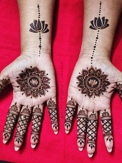 This striking design features a lotus mandala on the palm and a single lotus motif on the wrist, connected by a simple line. It's a perfect example of elegant minimalism.