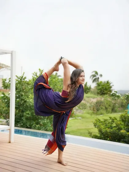 A saree doesn't stop the practice. Here, I'm holding Natarajasana, or Dancer's Pose, which requires immense balance, focus, and deep back and shoulder flexibility. Yoga isn't about the clothes you wear or the place you practice; it's about the presence and awareness you bring to the mat.