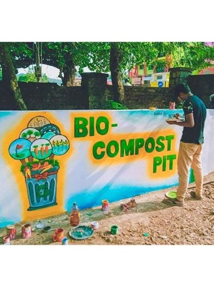 Here I am at work on the Bio-Compost Pit mural. This shot shows the process of painting the details and the materials I use. Community projects are a collaborative effort, and it's always rewarding to bring these ideas to life.