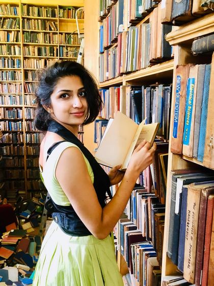 A moment of quiet reflection in a library from a few years ago. Books and memories have a way of intertwining, creating a bittersweet feeling.