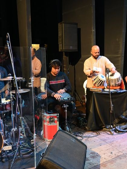 Our rhythm section, featuring drums, percussion, tabla, and bass guitar, laying down the groove for one of our stage performances.