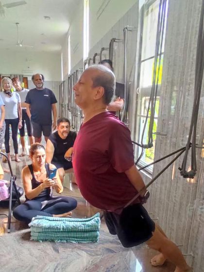 Using the wall ropes for a supported backbend, a technique we often explore in our retreats to open the upper back and shoulders.