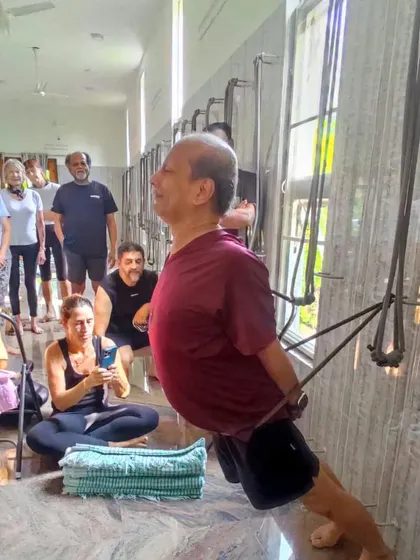 Using the wall ropes for a supported backbend, a technique we often explore in our retreats to open the upper back and shoulders.