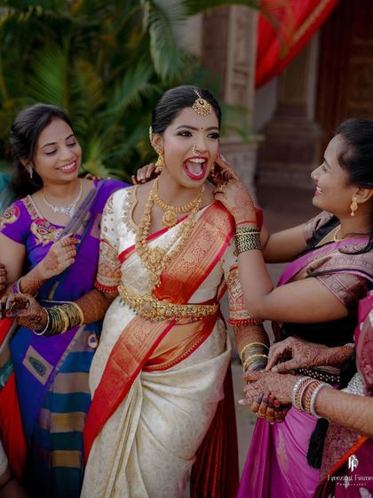 The bride, surrounded by her bridesmaids, sharing a moment of pure joy and laughter. These candid moments with friends are priceless.