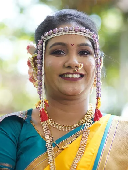 A classic bridal portrait. The bride's smile radiates happiness, and her makeup is perfectly balanced to enhance her natural features.