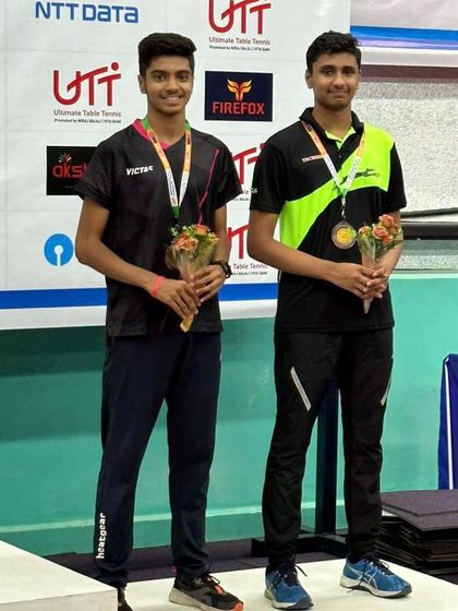 Akash K J and his partner on the podium after their doubles performance at the All India Ranking Tournament.