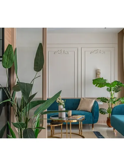 This shot captures the balance between the bold sofa and the neutral background, a key principle in our modern design approach. The plant adds a natural, organic element to the structured space.