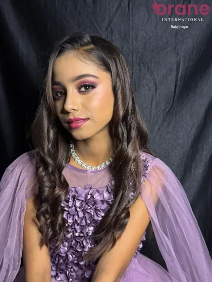 A close-up of the 'Glam Doll' hairstyle, showing the detail in the soft curls and side parting. These are the foundational styling skills that we ensure every student masters.