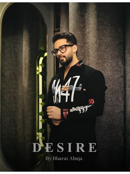 A pensive pose in the AK-47 shirt, a piece that is crafted for the modern gentleman who appreciates style and sophistication.