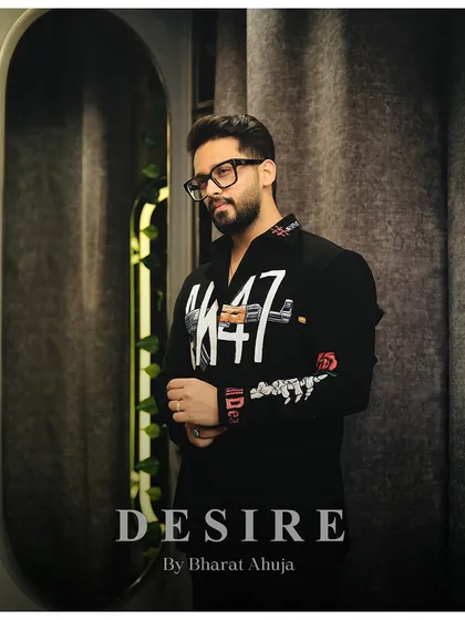 A pensive pose in the AK-47 shirt, a piece that is crafted for the modern gentleman who appreciates style and sophistication.