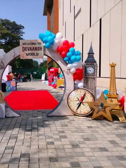 This "Around the World" themed entrance showcases custom-made props like Big Ben and the Eiffel Tower. It's a creative way to personalize a party and make it a unique experience for guests.