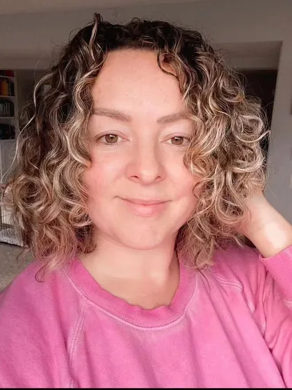 The reference photo for the second portrait of Debi, showing her curly hair and gentle smile.