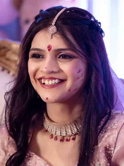 A candid moment of pure joy during the Haldi ceremony. The bride's infectious smile says it all.
