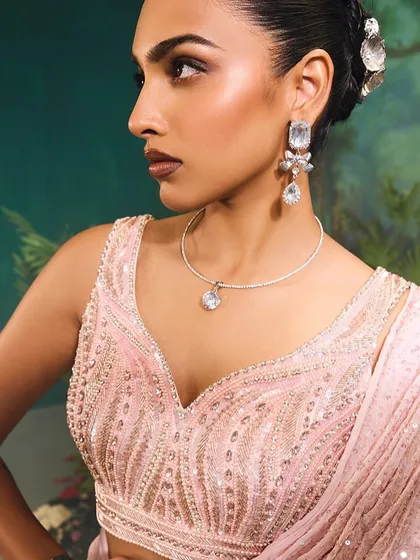 The Nysa Saree Set, breaking away from traditional silhouettes with its modern cut-out blouse and versatile drape, all in a beautiful shade of pink.