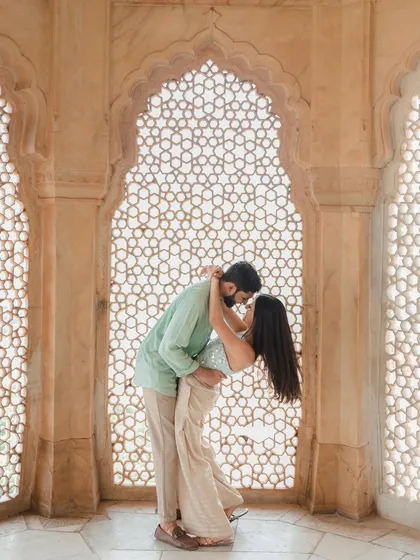 Framed by the intricate architecture of Jaipur, their story unfolds. We love playing with light and shadow in historic locations to create pre-wedding photos that feel both regal and deeply personal.