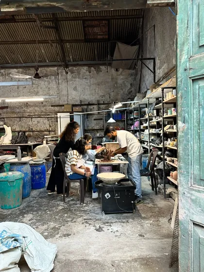 The joy of making your own Ganesha. A family works together in our studio, learning to sculpt their idol with guidance from our instructors.