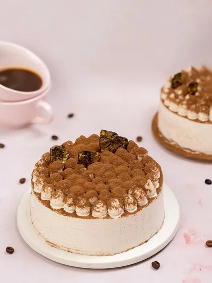 To capture the essence of this Tiramisu cake, I included coffee beans and a cup of espresso in the background. The dusting of cocoa powder on top is highlighted to showcase its texture and classic flavour profile.
