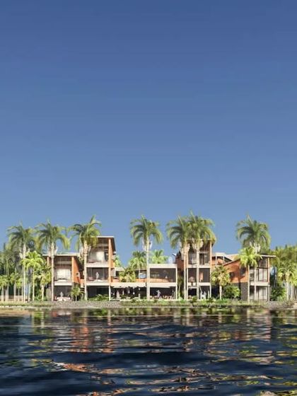 The reflection of the retreat in the calm river water emphasizes the project's harmonious integration with its site.