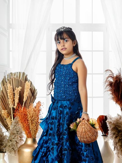 A princess in royal blue. With her tiara and elegant gown, she looks poised and beautiful in this classic fairy tale portrait session.