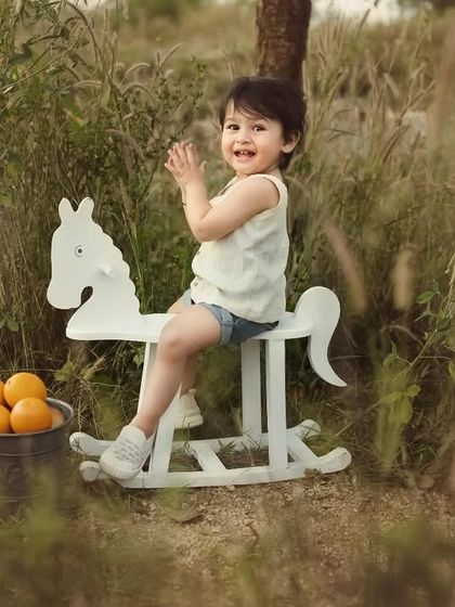 Somewhere in the wild. This little boy is having a wonderful time on his rocking horse, surrounded by tall grasses. Outdoor sessions are perfect for capturing a child's sense of adventure.