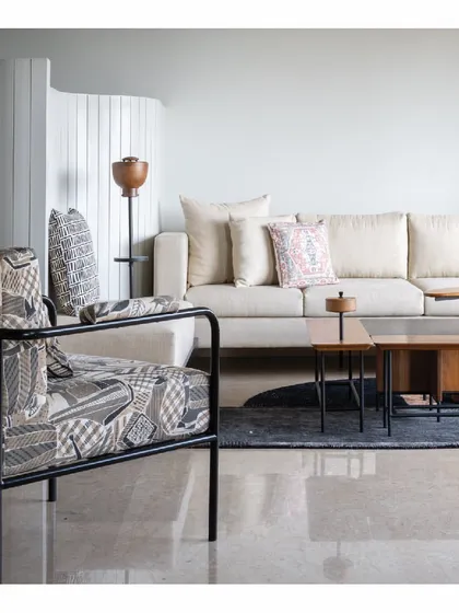 This living room in our Powai House project is a study in texture and form. A custom-patterned armchair sits beside a plush, neutral sofa, creating a dynamic yet balanced composition. The space is designed to feel open and airy, a calm retreat within a bustling urban environment.