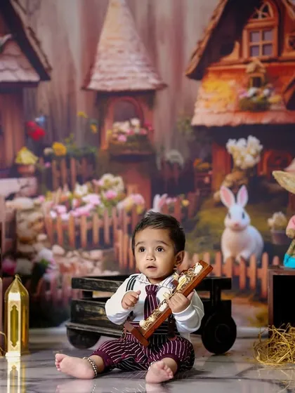 Our little bunny boy sits in a rustic village scene, perfect for an Easter or spring-themed photoshoot.