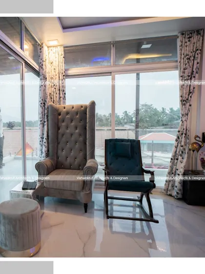 A seating area within the Rock Villa's master suite. The high-back armchair and plush ottoman create a perfect reading nook with a view, demonstrating my focus on creating functional comfort.
