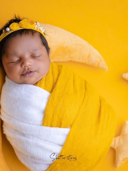 A close-up of the "mango softy" baby, showing the sweet details of the yellow headband and the baby's serene expression.