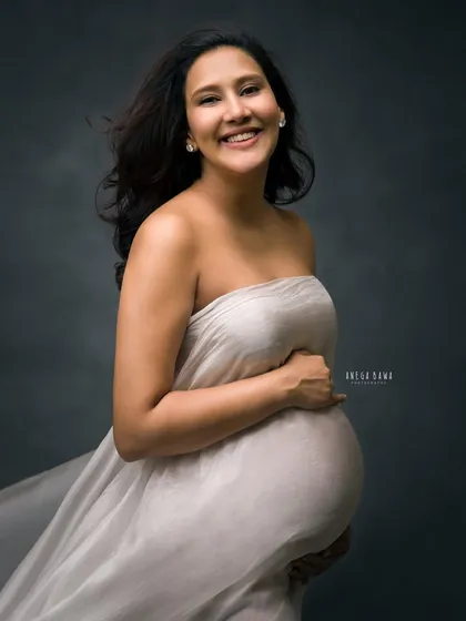 A joyful smile amidst a moody setting. This portrait proves that dramatic lighting can still capture happiness and warmth, creating a beautiful contrast.