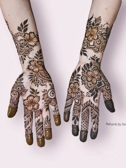 A full view of both hands, featuring complementary floral designs in a bold, graphic style.