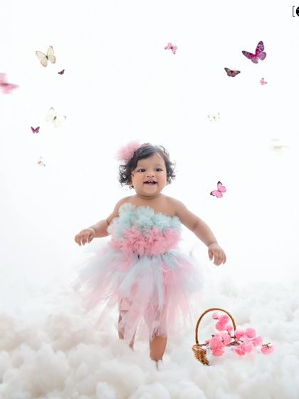 Walking on clouds and surrounded by butterflies, this little girl in her pastel tutu is living in a fairytale.