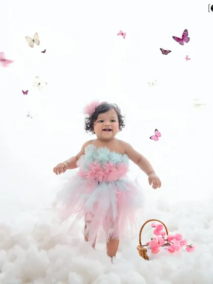 Walking on clouds and surrounded by butterflies, this little girl in her pastel tutu is living in a fairytale.