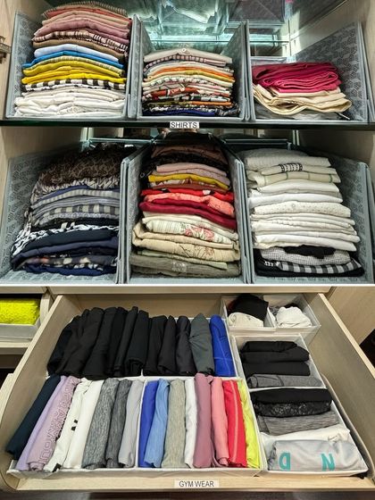 A side-by-side view of folded shirts on shelves and vertically folded gym wear in a drawer, demonstrating different techniques for different clothing types.