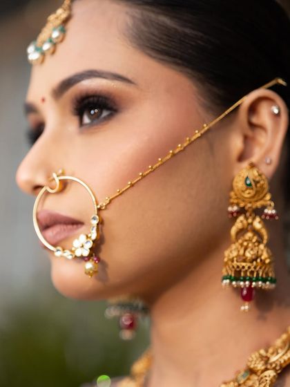 A detailed side profile showcasing the sharp wing, the beautiful nath, and the perfectly blended skin. Every detail matters for the perfect bridal shot.