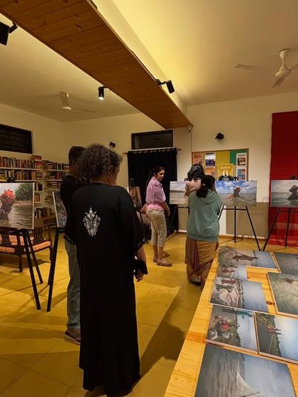 More visitors exploring the powerful photography at the "Chronicles of the Tides" exhibition.