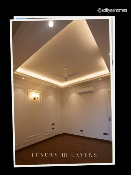 Luxury is layered. This room showcases our expertise in combining different elements like cove lighting, detailed wall panels, and rich wooden flooring to create a cohesive and elegant space.