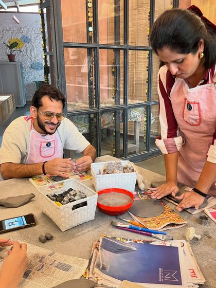 A shared moment of creative calm. This couple is enjoying a hand-building session, a perfect way to connect and de-stress together.