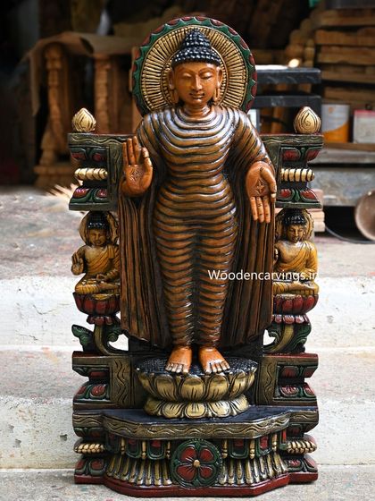 Another standing Buddha statue, this one flanked by smaller seated Buddhas, creating a complete narrative piece.