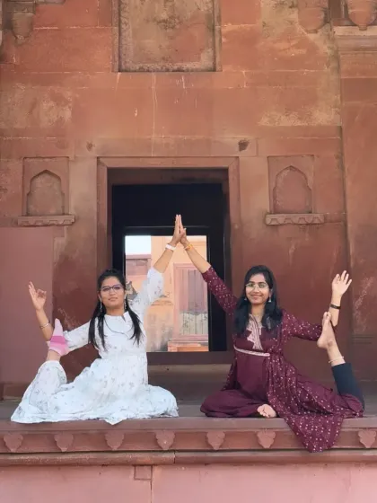 A partner yoga pose, Eka Pada Rajakapotasana (One-Legged King Pigeon Pose), creating a beautiful shape of unity and balance.