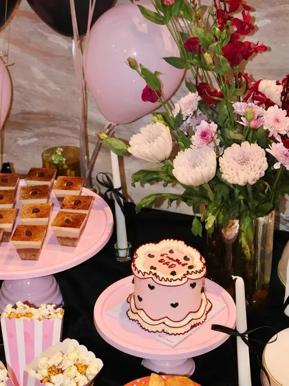 This is how we do home hosting. A beautiful dessert table we curated, featuring one of our vintage cakes alongside other sweet and savory bites.