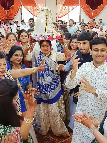 A traditional ritual in progress, with family members dancing and celebrating.