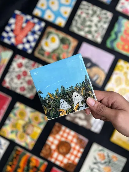 Who knew ghosts could be this cute? This hand-painted tile, featuring some shy little ghosts peeking out of the leaves, is part of a massive 166-tile wall project we’re working on.