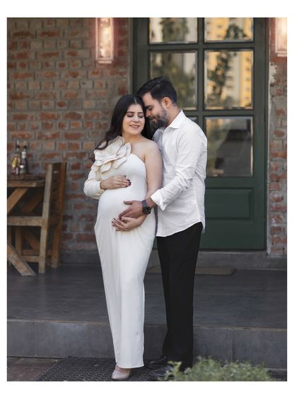 A quiet moment of togetherness for an expecting couple during their outdoor maternity photoshoot.