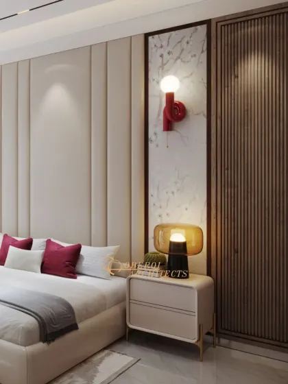 A detail of the bedside, showing the unique wall sconce and the combination of textures, including a padded headboard, marble inlay, and fluted wood paneling.